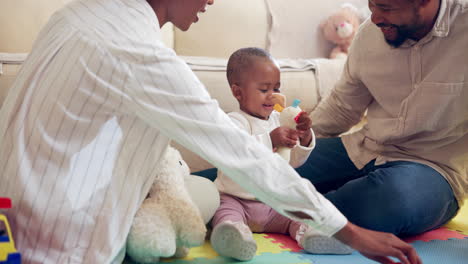 family playing with baby at home