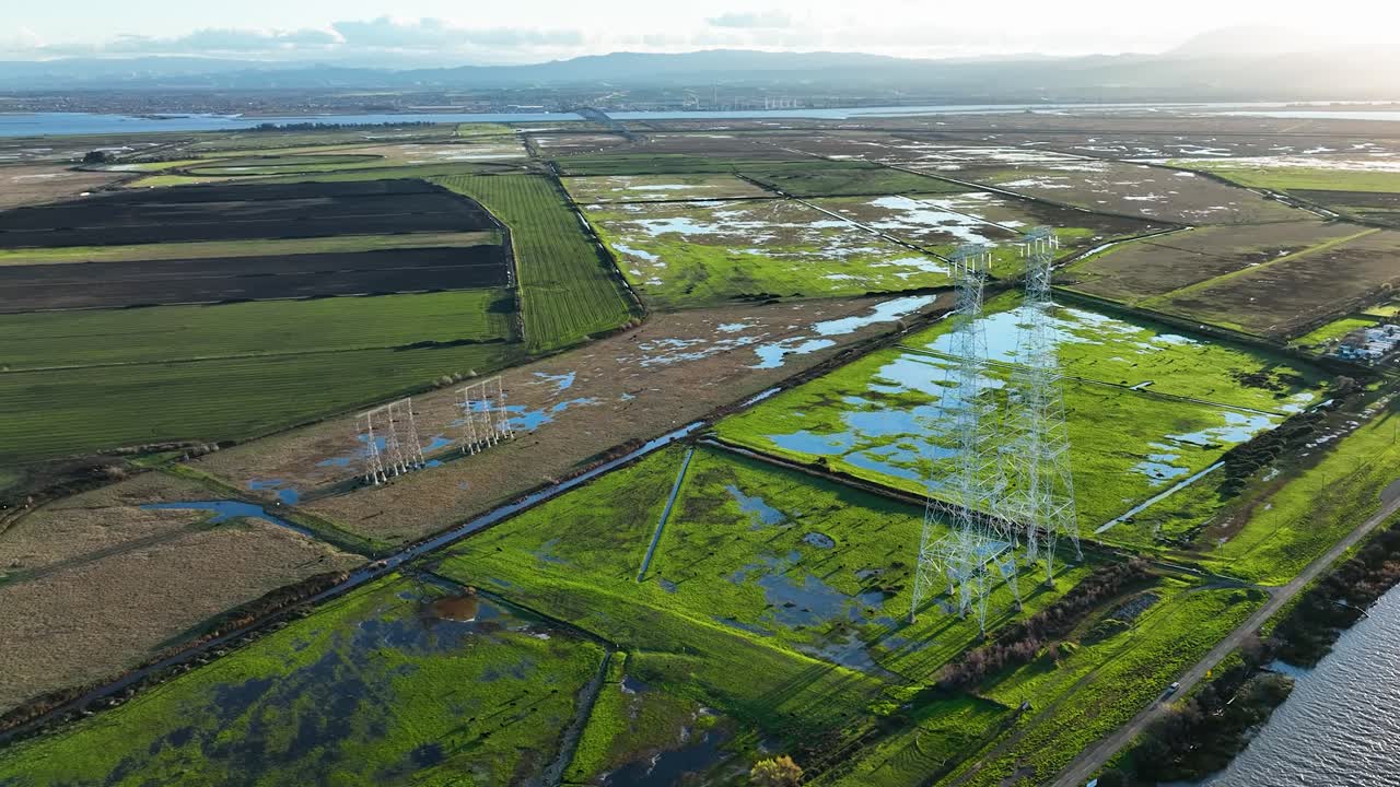 Aerial view of Sherman Island Marshy fields and Electric power lines on Wild Life Area, California