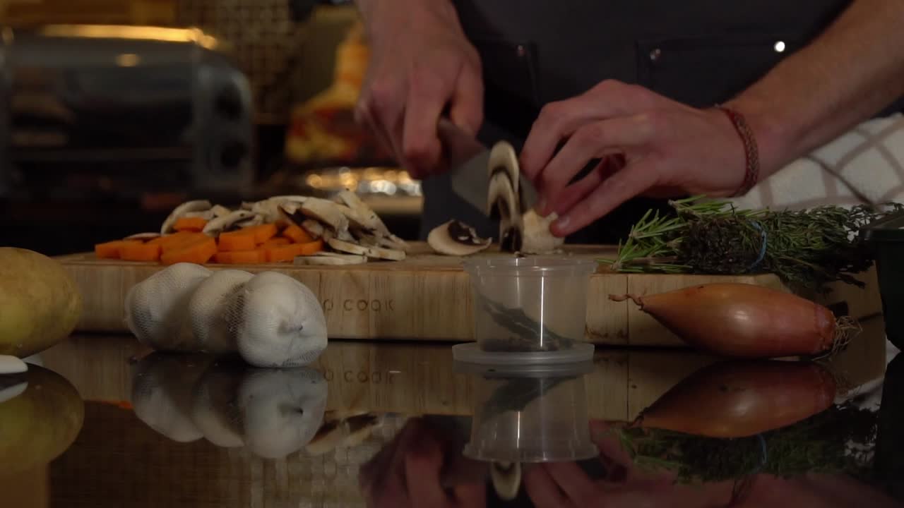 Culinary Artistry: Chef's Skillful Mushroom Slicing on Vegetable-Filled Board