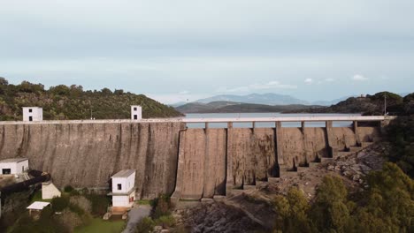 Water-reservoir-dam-in-South-Sardinia,-rising-establisher-reveal-artificial-lake