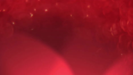 animation of glowing spots of light moving over red background