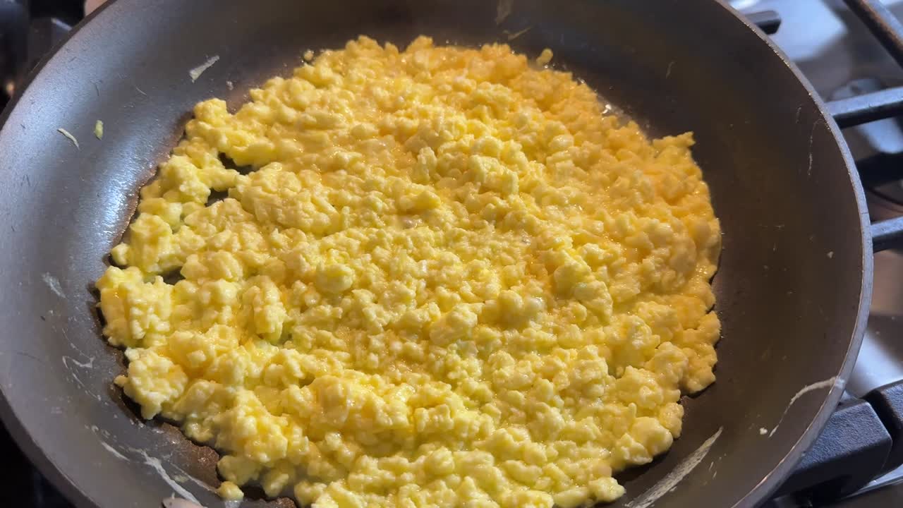 scrambled eggs cooking in a pan