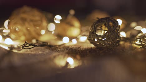 close-up christmas garland and handmade balls on a playd with golden lights. christmas concept. home decor