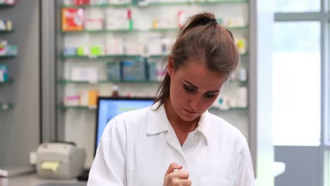 junior pharmacist mixing a medicine