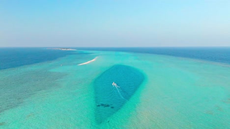 an awe-inspiring aerial drone view captures the rasdhoo sandbanks glowing under the soft, golden light of sunset in the maldives.