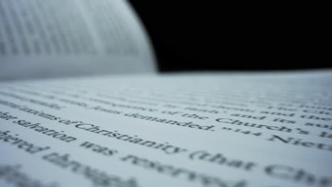 detailed view open book lying on table. white book sheets with english text