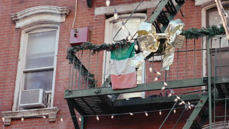holiday decorated fire escape in a new york city building