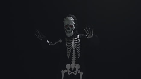 Studio-Shot-Of-Child-Dressed-Up-In-Skeleton-Costume-Trick-Or-Treating-At-Halloween-Dancing-Against-Black-Background-7