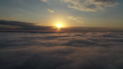 sunrise or sunset over a sea of clouds