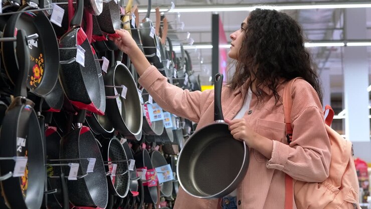 Woman Shopping for Pans in a Supermarket