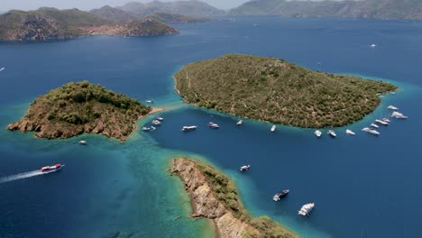 aerial footage capturing the island groups of hawaii united states with yachts and boats docked at the shore around the island