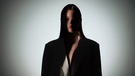 silhouette of a woman in a blazer with dramatic lighting