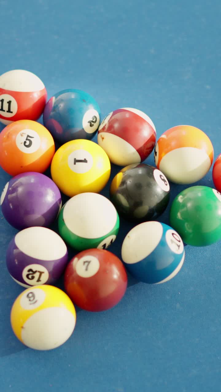 White ball hitting pool balls and spread them