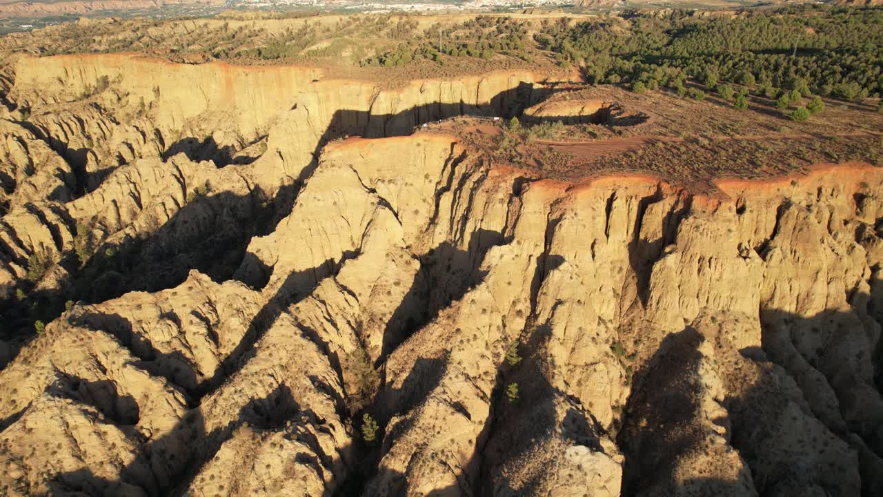 Badlands at sunset. Eroded terrain, gullies, and ravines. Aerial view. End of the World Lookout. Purullena. Spain