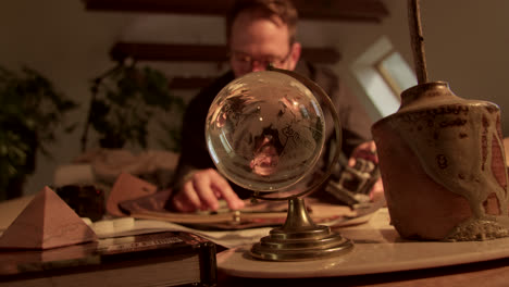 man looking at a globe on his desk