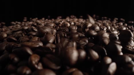 zoom out macro video of falling coffee beans