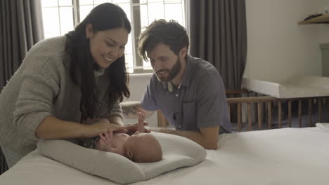 happy parents bonding with their newborn baby