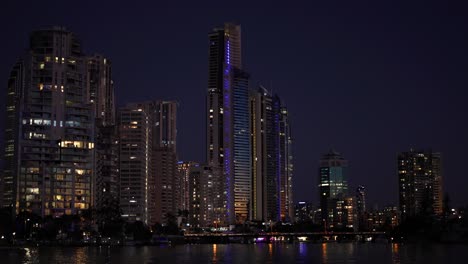 illuminated buildings reflecting on water at night