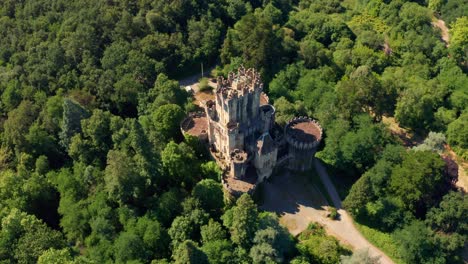 old castle among greenery forest in summer