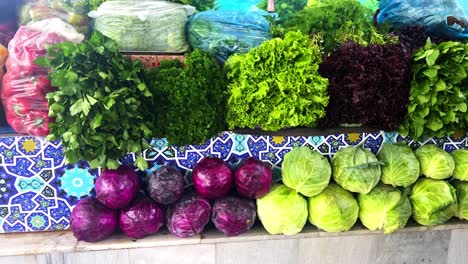 medium shot moving past fresh vegetables in a supermarket grocery