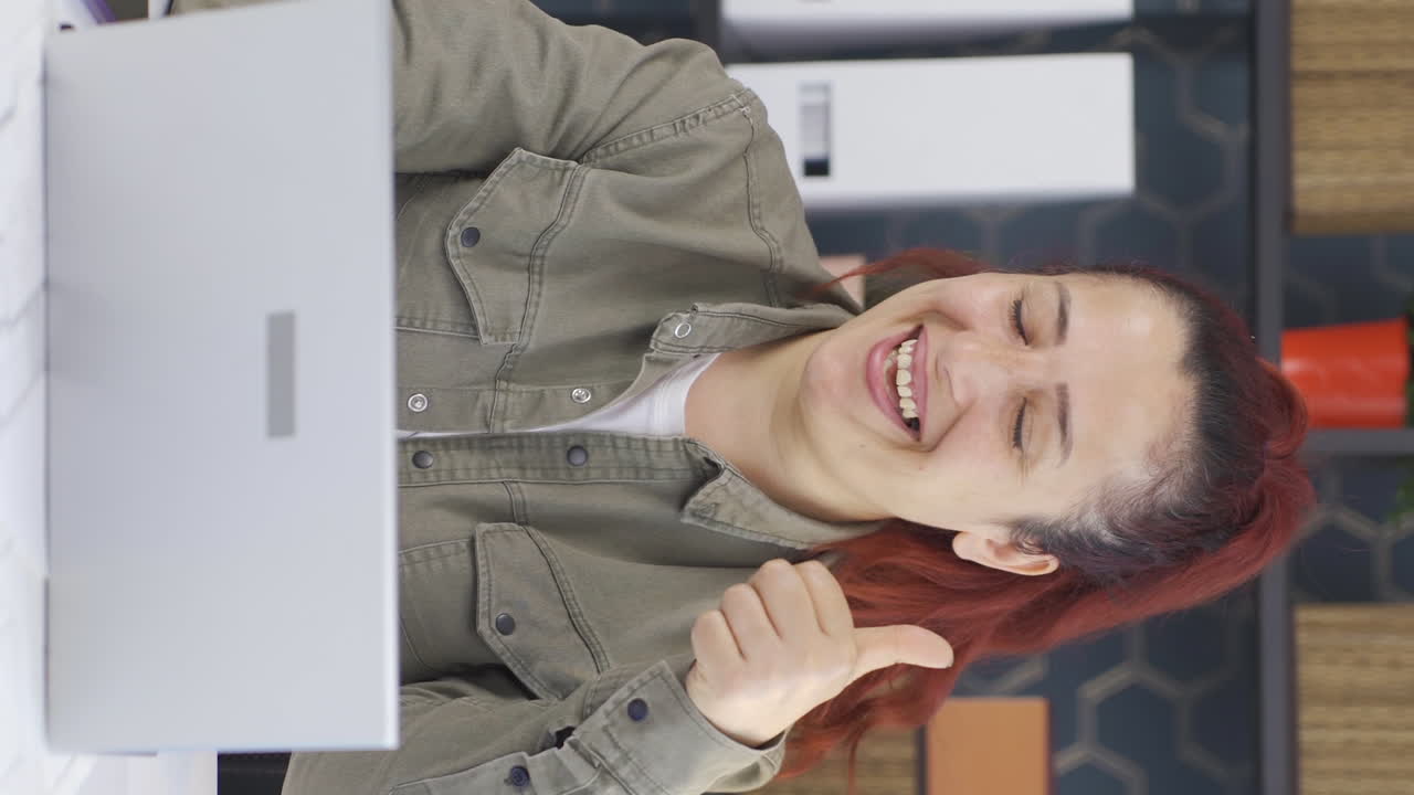 el video vertical de una mujer de negocios trabajando en una computadora portátil se satisface.