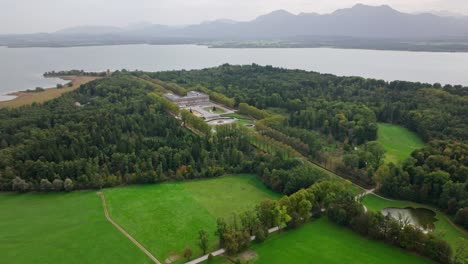 herrenchiemsee new palace surrounded by green trees by chiemsee lake in herreninsel island, bavaria, germany