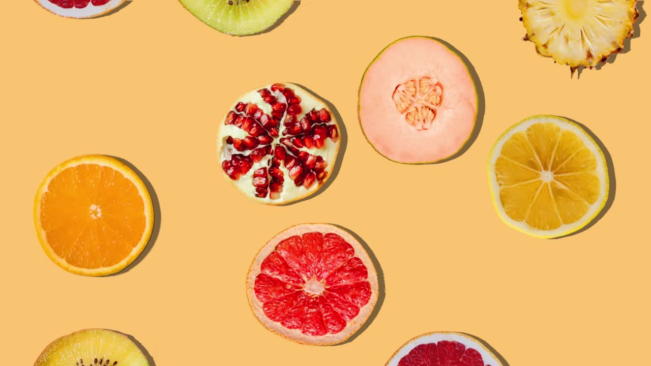 Background of fruit slices falling. Fresh fruit. Loop. 4K.
