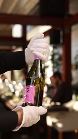 waiter opening champagne bottle