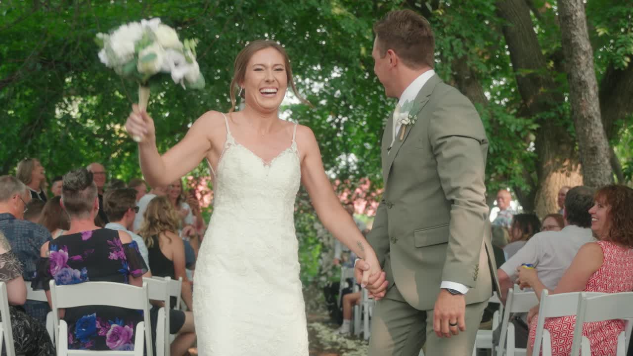 Close Up of Bride and Groom Kissing Under Falling Confetti in Slow Motion