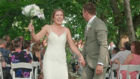 close up of bride and groom kissing under falling confetti in slow motion