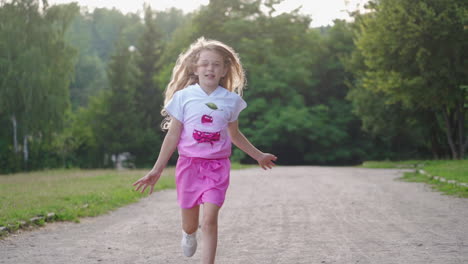 cute girl in park. sweet little girl running outdoors