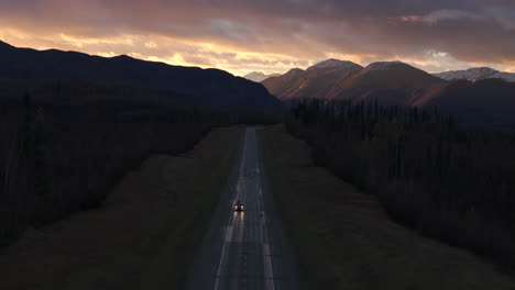 epic alaska highway stretches toward glowing sunset horizon