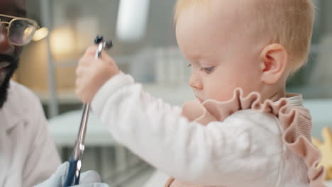 African-American-Doctor-and-Caucasian-Baby-Playing-with-Stethoscope