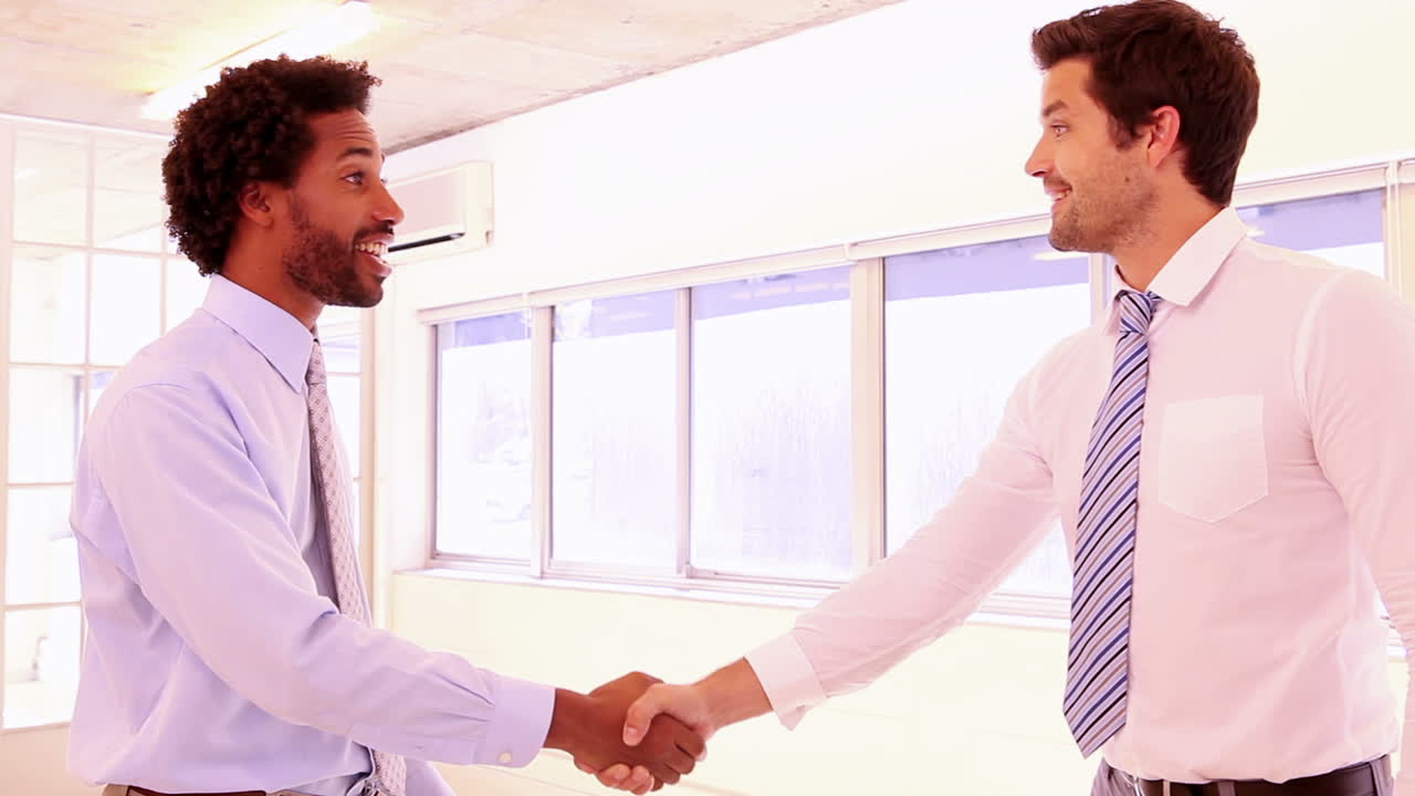 Businessmen shaking hands and smiling