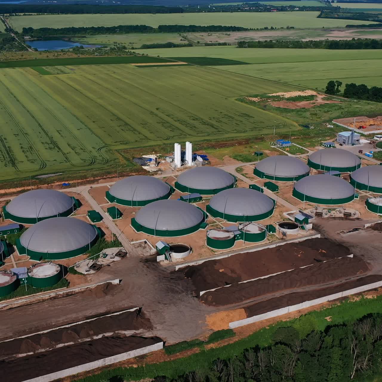 Organic biogas plant in the green farm plantations. Biomass production for saving nature resources. View from above