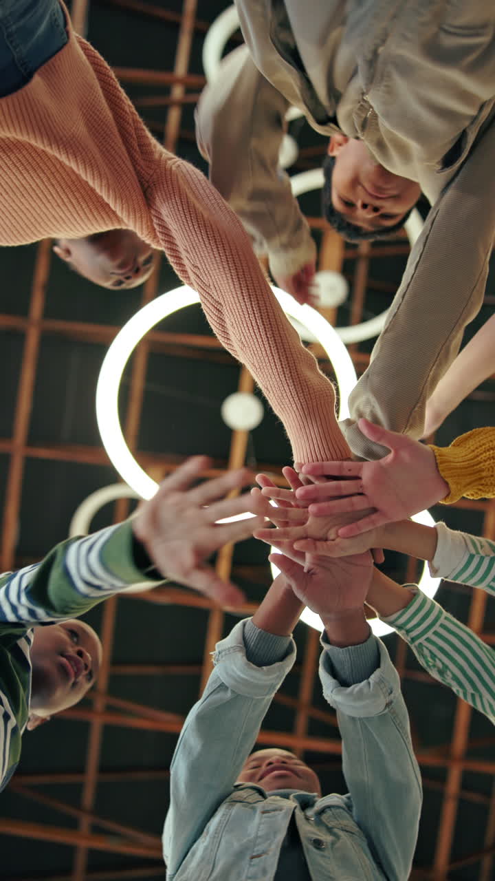Diverse Group of Young People Stacking Hands for Teamwork