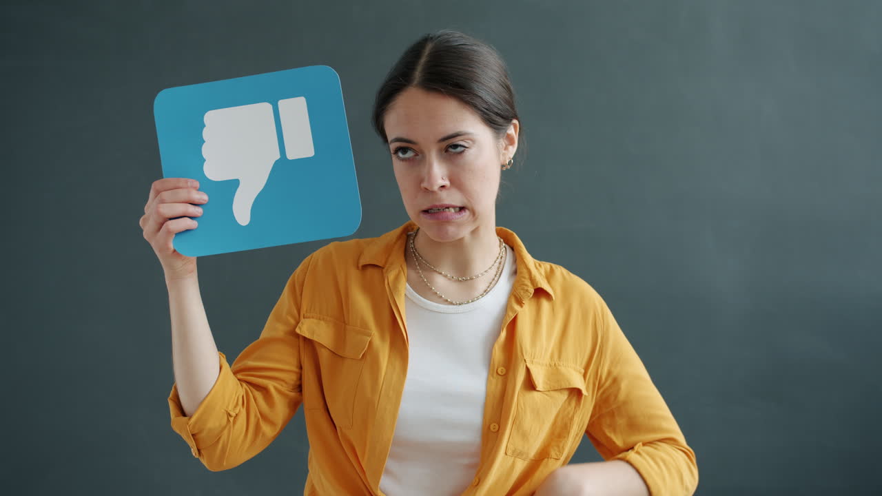 Woman Holding a Thumbs Down Sign