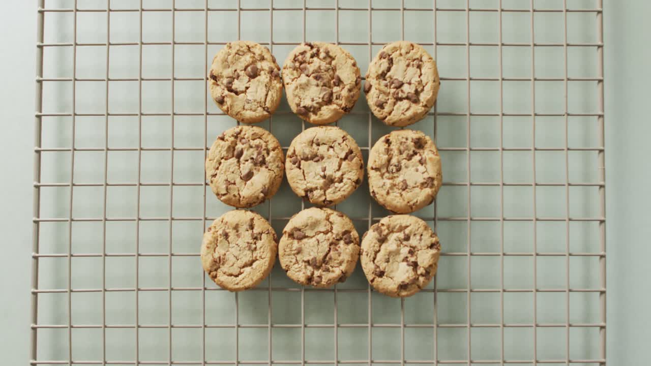 Video of rows biscuits on a baking rack over white background