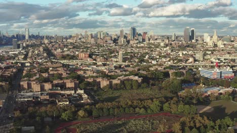 aerial rise over brooklyn new york city with housing projects and the bqe expressway, manhattan and downtown brooklyn skylines in the distance