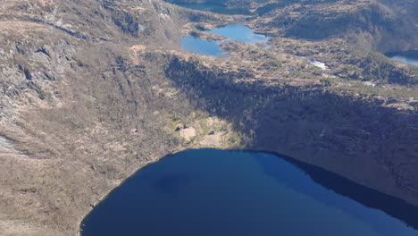 drone circling above kringlebotn mountain farm in matrefjellene, capturing the old buildings and the panoramic mountains