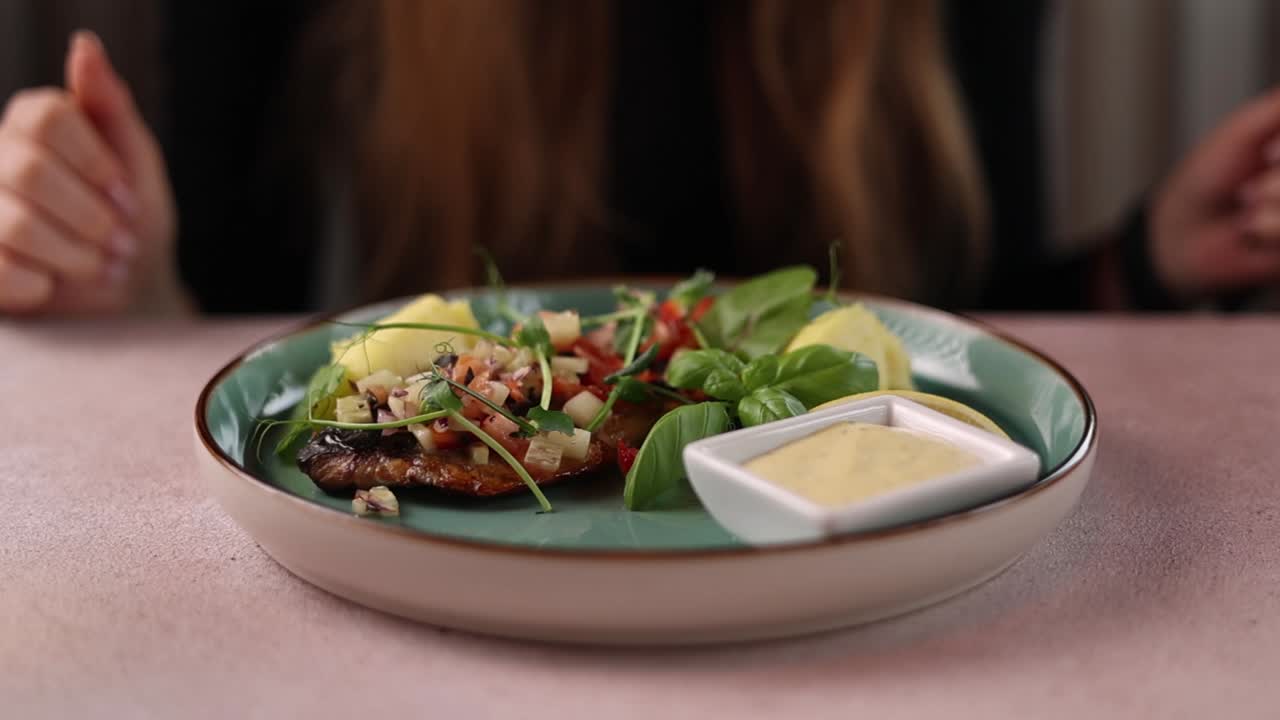 mujer comiendo un plato de pescado en un restaurante