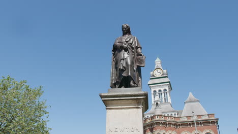 a statue of sir isaac newton shot from the front