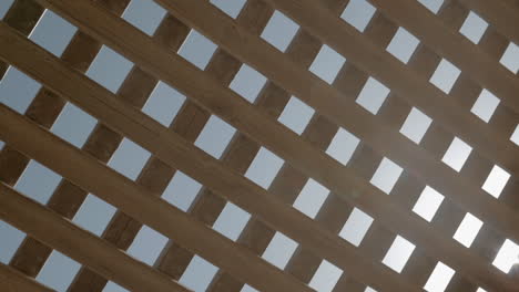 View-to-sky-and-sunshine-through-wooden-net-shed