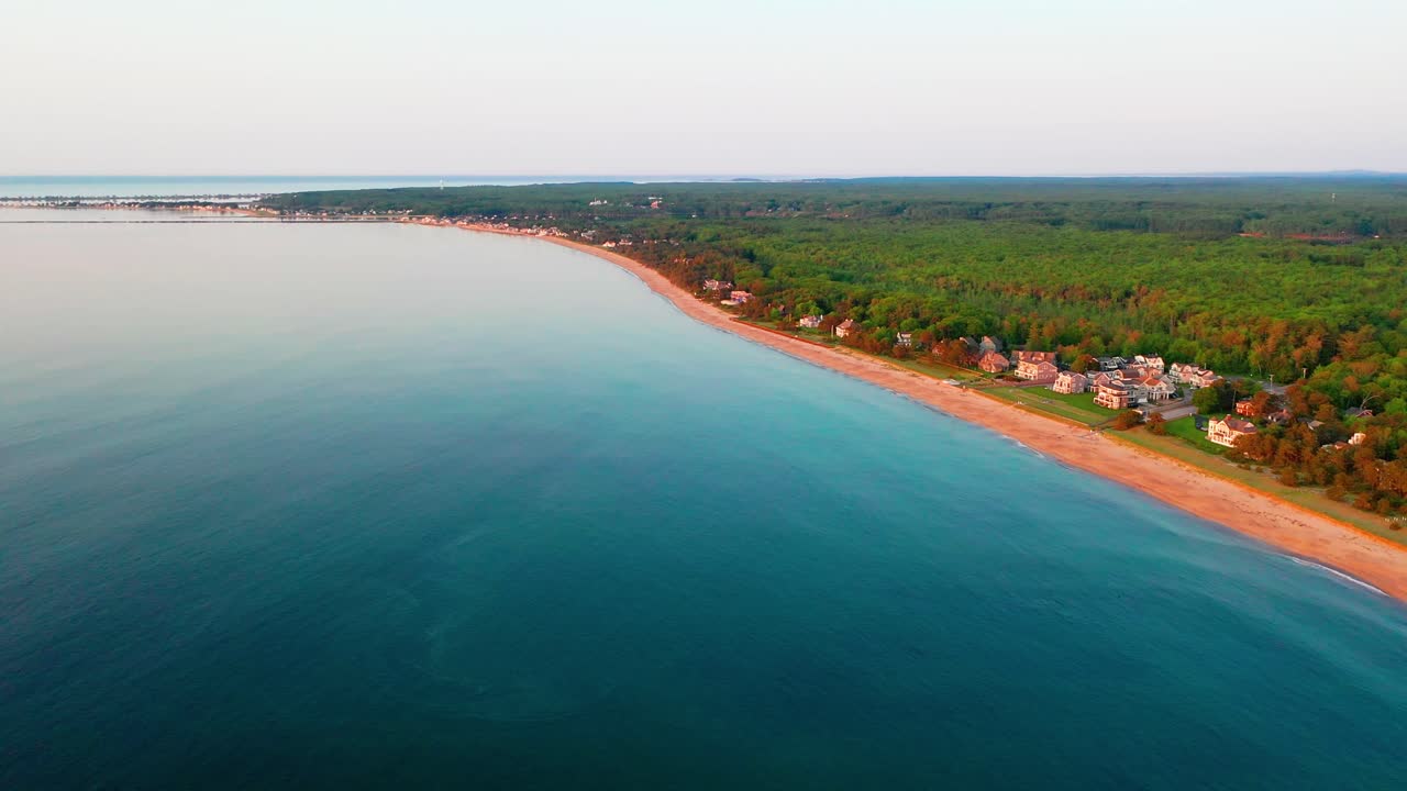 Scenic drone aerial view of Saco, Maine’s deserted beaches in the off-season. No tourists, just empty sand, vacation houses, Atlantic Ocean waves rolling along the beautiful New England coastline.