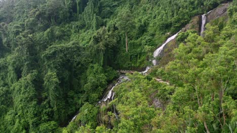 aerial-zoom-out-through-jungle-trees-on-a-mountain-in-Lombok-on-cloudy-day