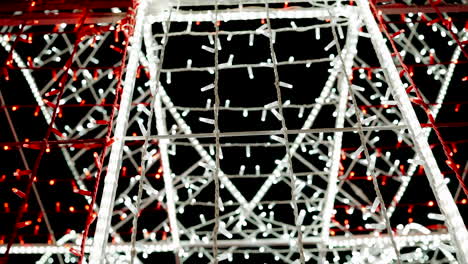 Interwoven red and white festive light strands