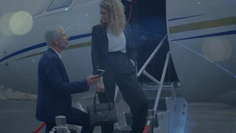 network of connections against caucasian businessman and businesswoman discussing at the airport