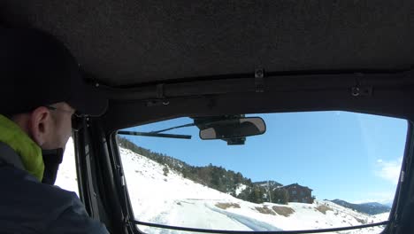 Time-lapse-of-a-man-in-a-UTV-driving-to-a-large-home-in-winter