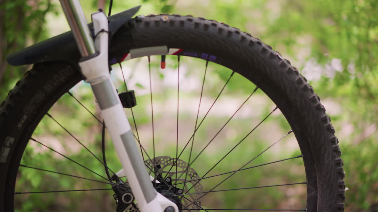 Bike Inspection Detailed, Closeup Of Bicycle Front Parts, Mechanic Examines Bicycle Suspension And Braking System, Close View Of Bicycle Front Wheel With Suspension And Disc Brake Components