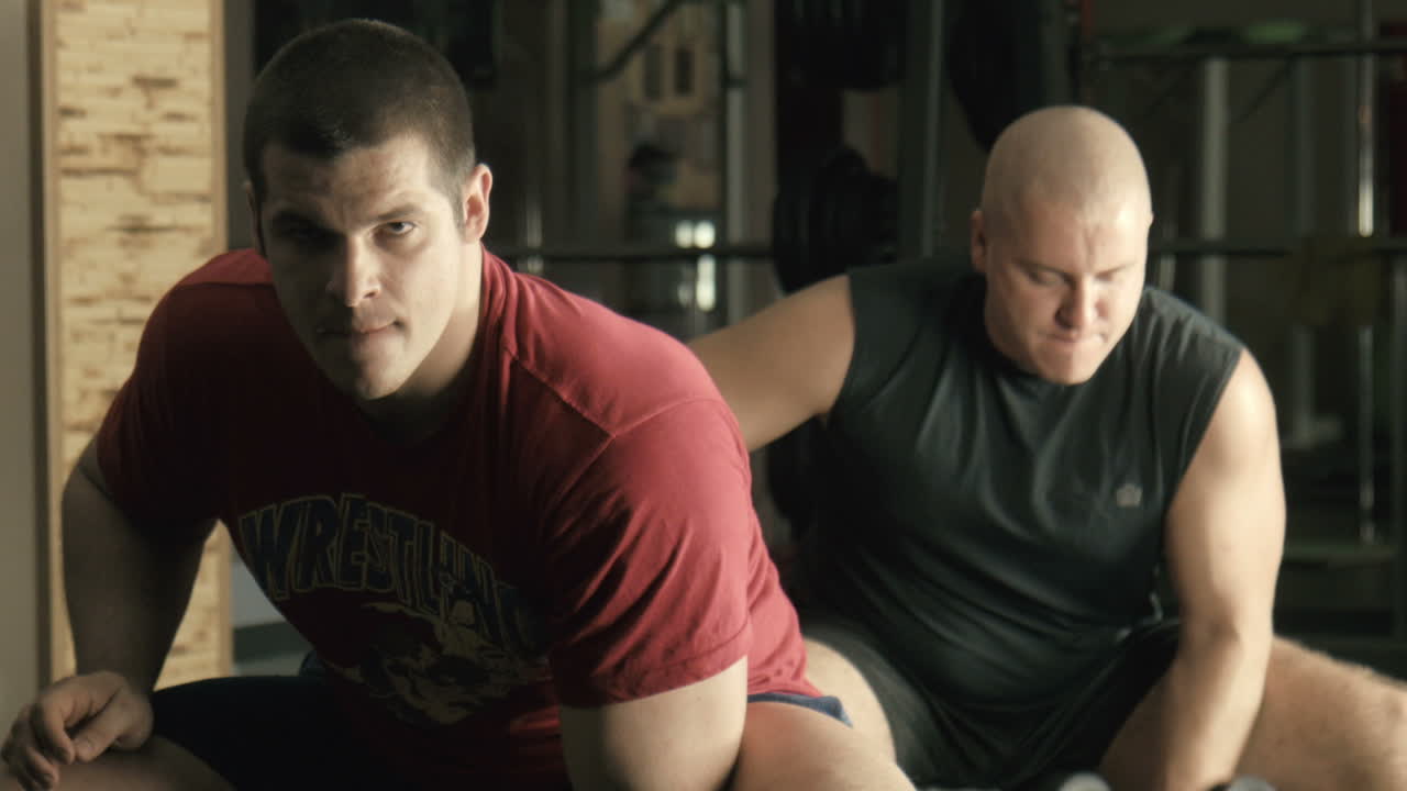 Two Men Showcase Strength Training Exercises in a Cozy Living Room